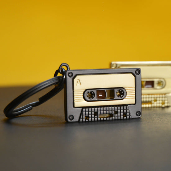 Oli Olsen Metalmorphose Matt Grey & Gold Cassette Tape Keyring