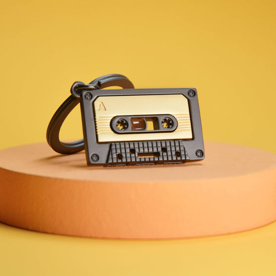 Oli Olsen Metalmorphose Matt Grey & Gold Cassette Tape Keyring